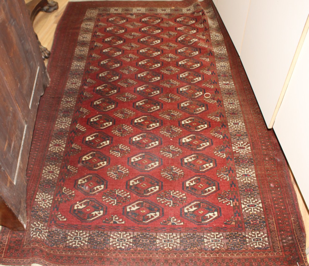 A Bokhara red ground rug, 200 x 123cm